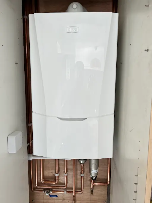 JR Heating Services engineer fitting a Worcester Bosch boiler in Barry